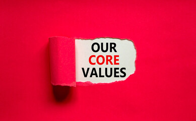Our core values symbol. Words 'Our core values' appearing behind torn purple paper. Beautiful purple background. Business, our core values concept, copy space.