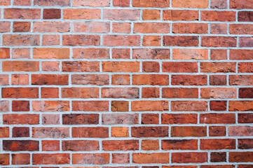 Old red brick wall. Abstract vintage background with spots and grains