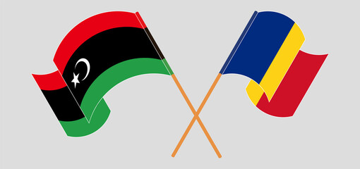 Crossed and waving flags of Libya and Romania