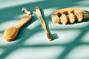 Waste-free bathroom accessories on light turquoise background with geometric shadows. Eco cosmetics...