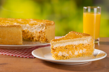 Orange juice and chicken pie with cheese on natural background