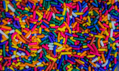 Fototapeta na wymiar bright and colorful candy sprinkles filling entire frame close-up food or topping for background