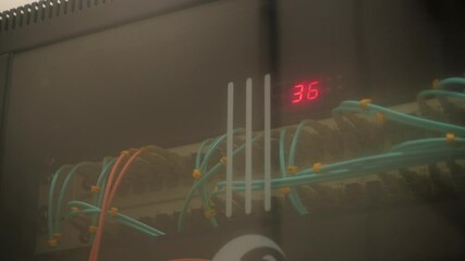 Control cabinet with breakers colorful buttons and display with digits in spacious plant workshop extreme close view