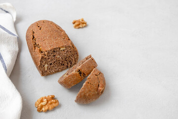 Freshly baked sourdough walnut bread on neutral grey background with space for text