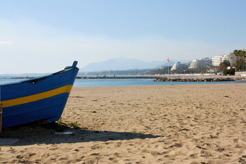 Beach with boats in the resort town of the Costa del Sol on the Mediterranean Sea.