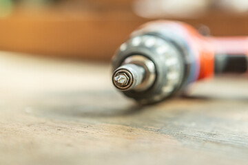 CLose-up of a cordless screwdriver on workbench