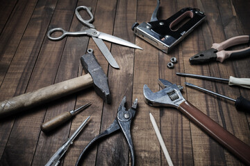 Set of different tools on vintage wood table background.