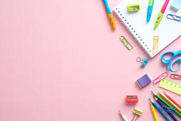 School supplies on pink background. Back to school creative flat lay.