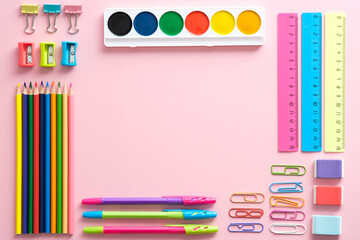 School supplies set on pink background top view. Creative back to school flat lay.