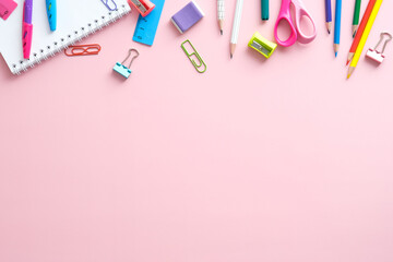 School equipment. Frame of school supplies on pink background. Flat lay.