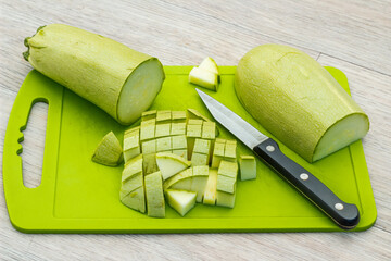 Zucchini sliced on a green cutting board. Fresh, ripe, tasty, natural vegetable