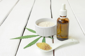 Cooking with cannabis concept. Weed infused products - thc oil, marijuana flour, sugar on white background with copy space