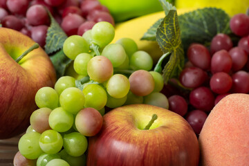 fruits detail. green grapes, purple grapes, apple, banana. good nutrition