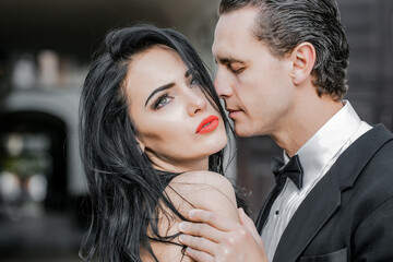 Handsome groom holds beautiful bride