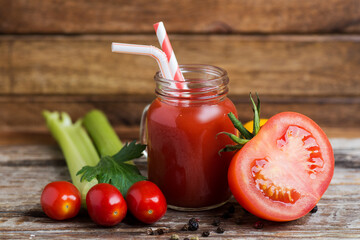 Sliced juicy tomato and tomato juice with celery