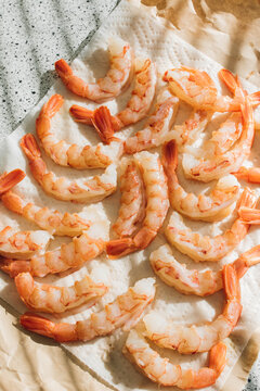 Raw De-shelled Prawns Shrimp With Tails On Paper Towel In The Sun 