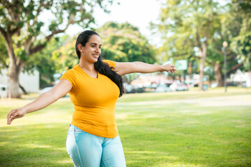 young latin woman in the park enjoying freedom