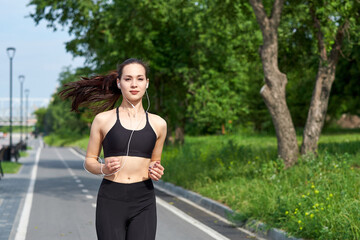 Running asian woman on running track. Morning jogging. The athlete training