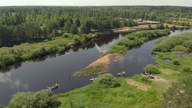 Drone point view of group people kayaker floating on water. Aerial drone view of group kayak in lake. Kayaking and Canoeing along the Riverbed Aerial View. Rafting. Tracking a Boat