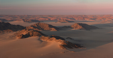 Fototapeta na wymiar Dunes and Ridges of the Namib Desert at Sunrise
