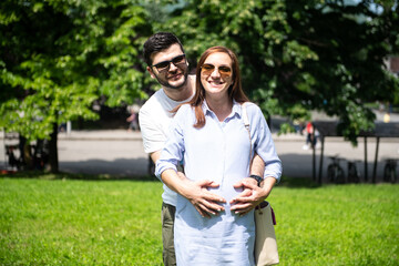 Happy Pregnant Woman and Her Husband in Park