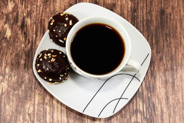 A cup of coffee with chocolate cakes