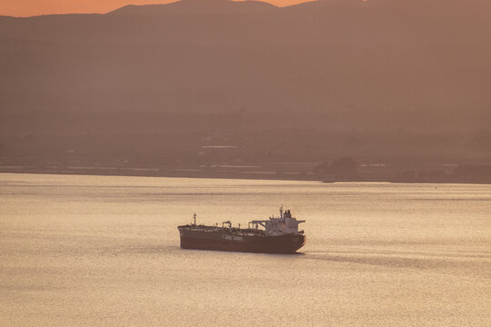 Sunset Colors With A Cargo Ship Travelling In The Messenian Gulf In Southern Greece