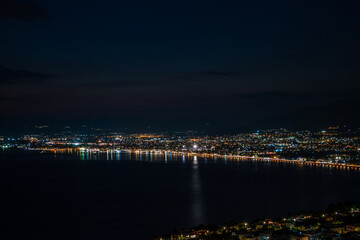 Fototapeta na wymiar Aerial night view of Kalamata city, Greece. Kalamata is one of the most beautiful cities in Greece and a popular tourist destination
