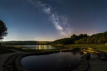 Fototapeta na wymiar starry night at reservoir lake with old roman thermal springs Os banos de Bande, Spain