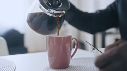 Exhausted businessman in suit pouring strong coffee in cup, energetic drink