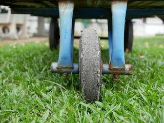 Fototapeta premium closeup of old black cart wheels in the garden.