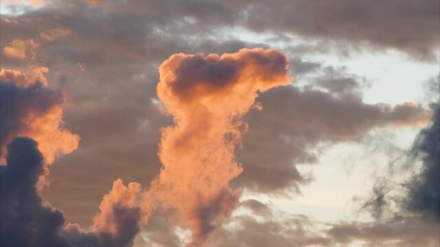 Time lapse of rolling puffy sunset clouds are moving, orange clouds time lapse. Clouds running across the cloudy sky. 4k Timelapse of white clouds with sunset sky background