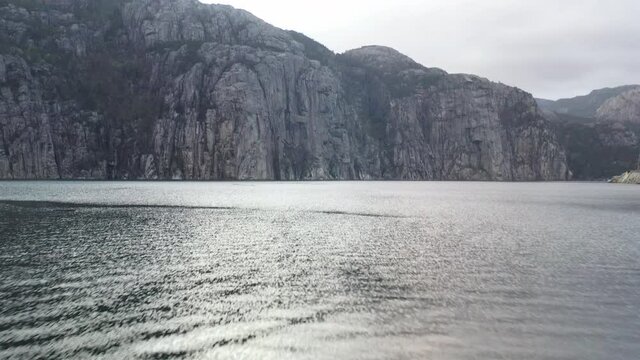 Fast drone shot over campfire with fjord in background, Norway,