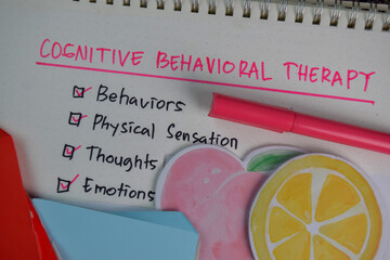 Cognitive Behavioral Therapy write on a book with keywords isolated on Wooden Table. Chart or mechanism concept