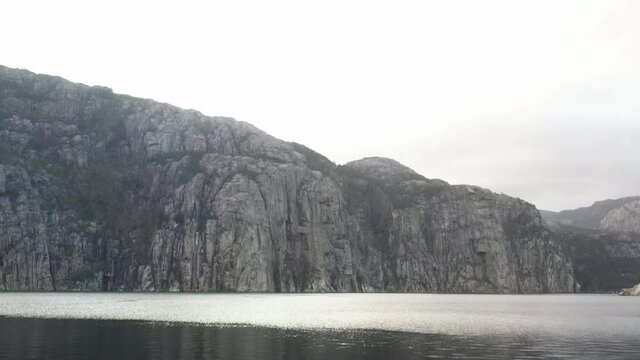 Drone tilt shot over campfire with fjord in background, Norway,