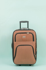 Travel suitcase with a handle on a blue background.