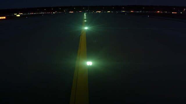 Green lights on airport runway at night