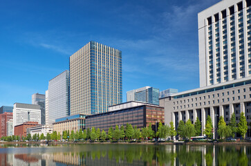 Skyscrapers of Marunouchi district reflecting in the water of Edo castle outer moat.  Tokyo. Japan
