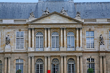 Fototapeta na wymiar Paris, France : The ornate baroque facade of the French National Archives museum in the Marais district, housed in the 18th century Soubise palace, built on 14th century foundations..