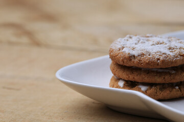 Freshly baked cookies on white plate. Cookies on table with space for text. Dessert