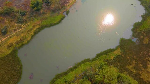 Aerial Over Lake At Grounds Of Janhangirnagar On Sunny Day. Dolly Back