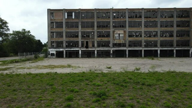 Drone tracking shot near abandoned factory. Motion movement right,