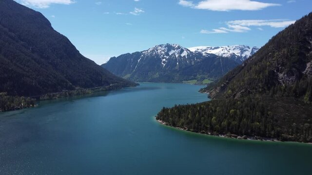Amazing drone shot of a beautiful lake surrounded by mountains. Achen lake (Achensee) in Austrian Tyrol, Alps.