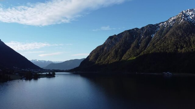 Sunrise by amazing glacial lake Achensee in mountains Alps.