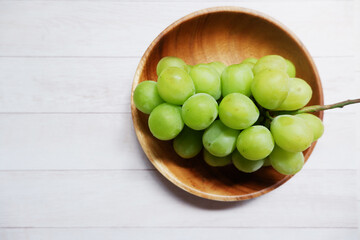 green grape on wooden dish and table background. Fresh organic concept. Shine Muscat, grape, fresh green, natural, natural food, Healthy.