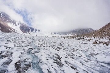 Man doing hiking in the high mountains on the glacier