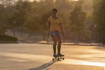 Obraz premium A young white Caucasian skateboarders ride skateboards at night