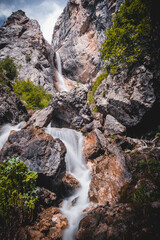 Waterfall in the mountains in spring with refreshing splashes