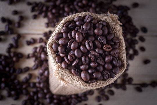 Close-up image of coffee beans in hemp sacks on the table,top view