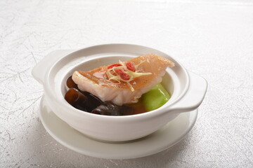 steamed fresh cod grouper fish fillet with vegetable, herb and black bean soy sauce in white background asian halal seafood fine dining menu